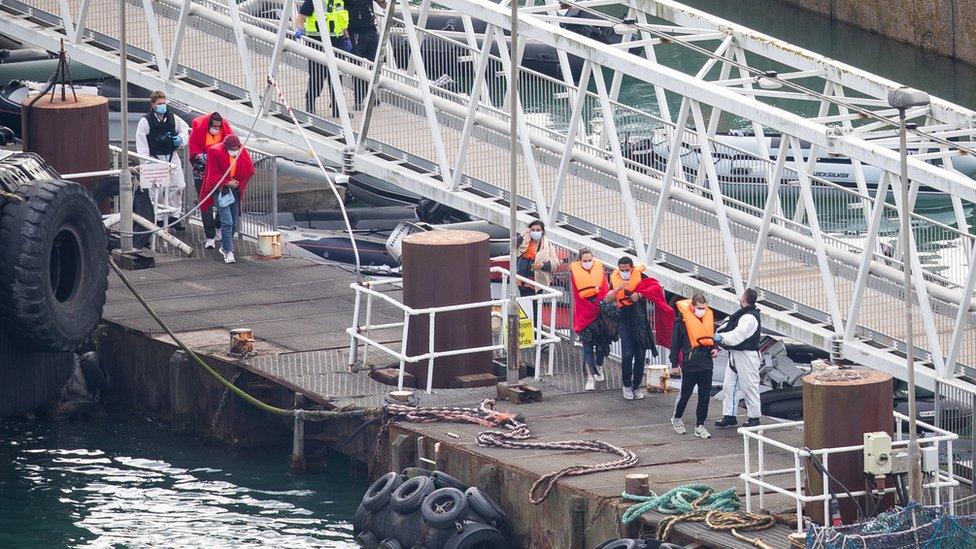 A group of people, thought to be migrants are brought into Dover by Border Force officers on Wednesday after crossing the English Channel.