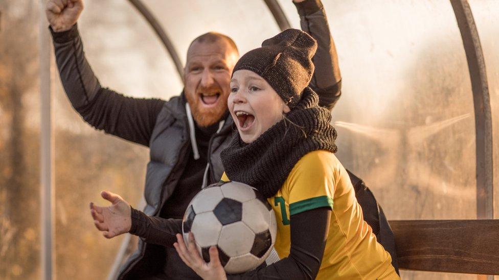 Dad cheering with daughter