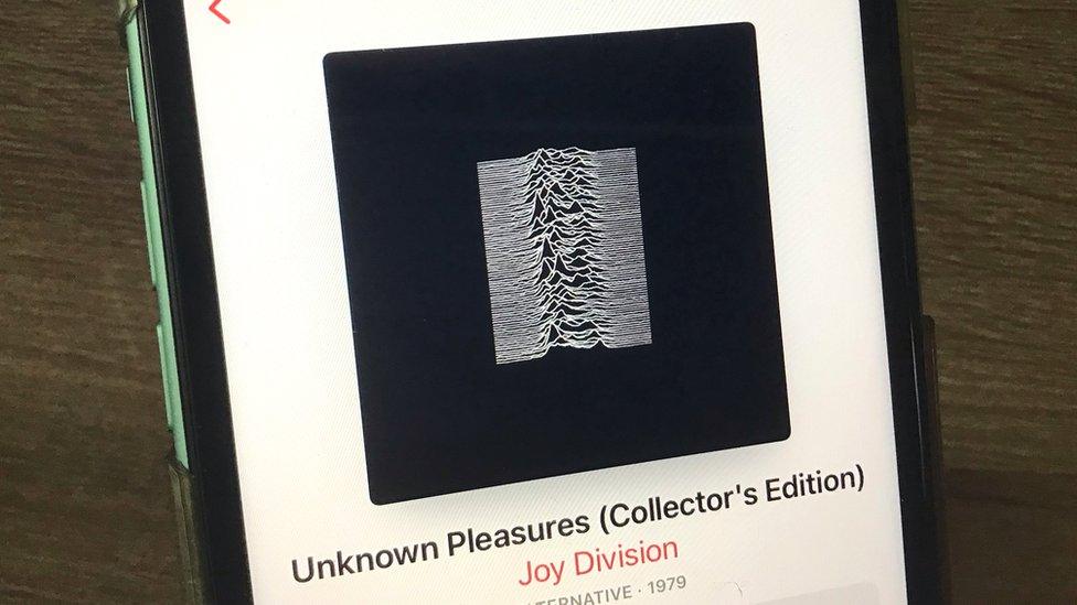 Phone showing Joy Division's Unknown Pleasures album