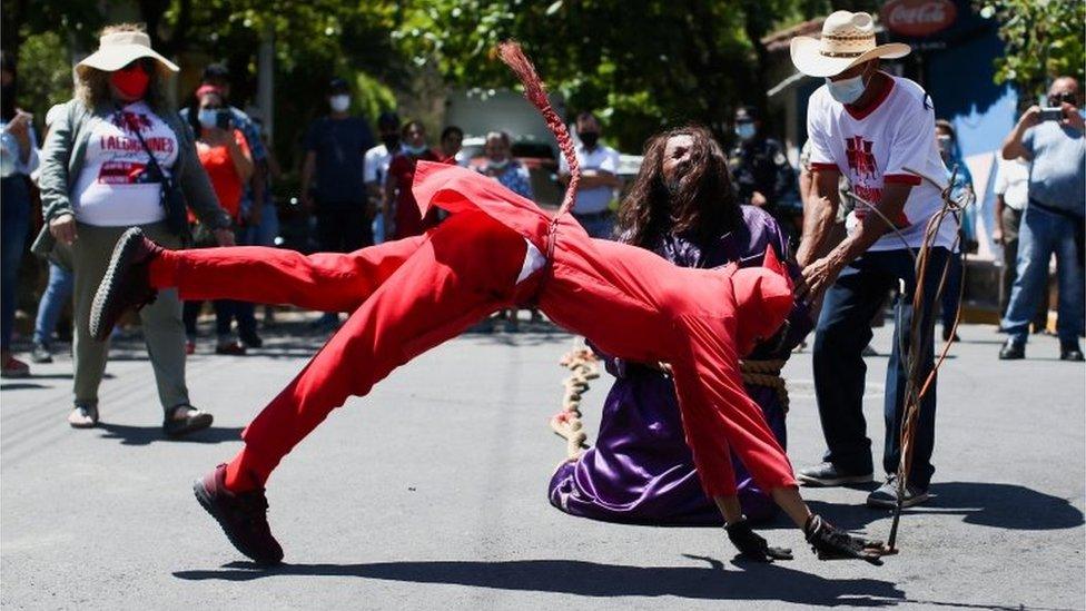 A man dressed as a demon participates in a ceremony known as Los Talciguines, as part of religious activities to mark the start of the Holy Week in Texistepeque, El Salvador, April 11, 2022.