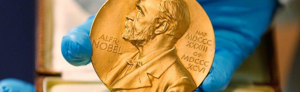 A national library employee shows the gold Nobel Prize medal awarded to the late novelist Gabriel Garcia Marquez, in Bogota, Colombia