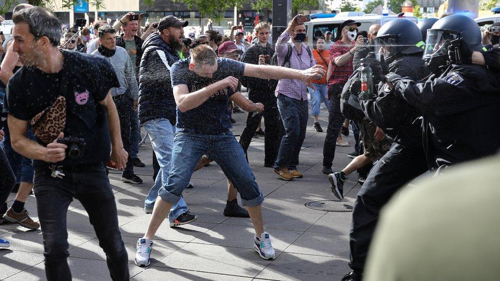 Police use pepper spray in a clash with anti-lockdown demonstrators in Berlin