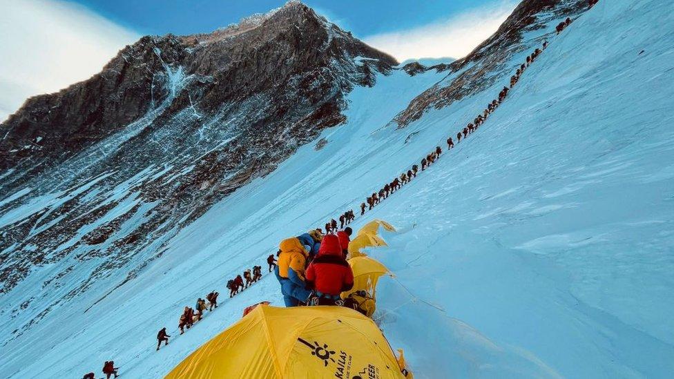 Climbers ascend to the summit of Mount Everest