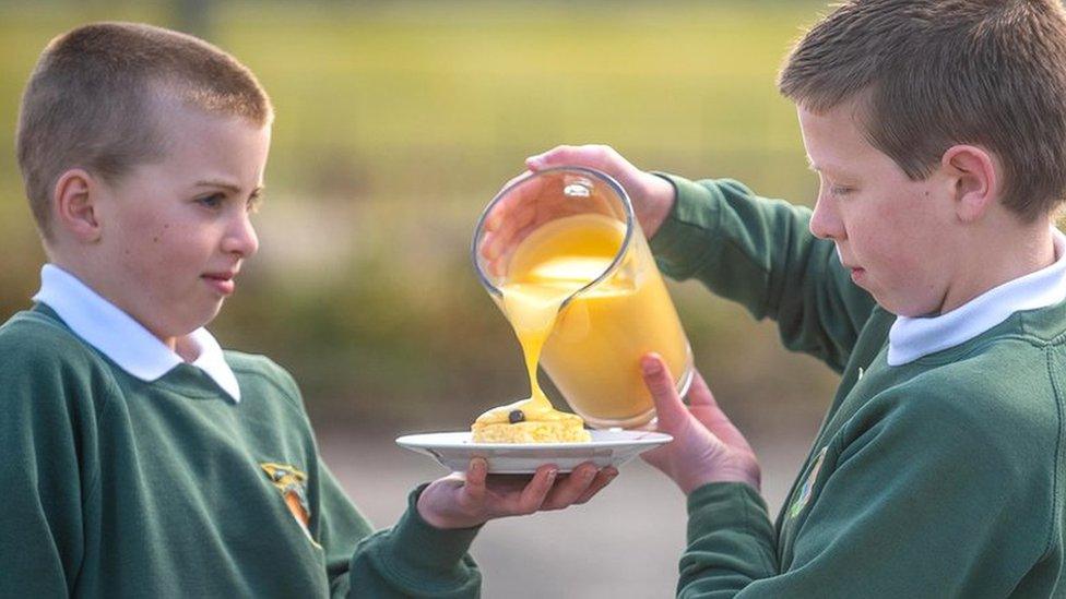 Schoolboys with dessert