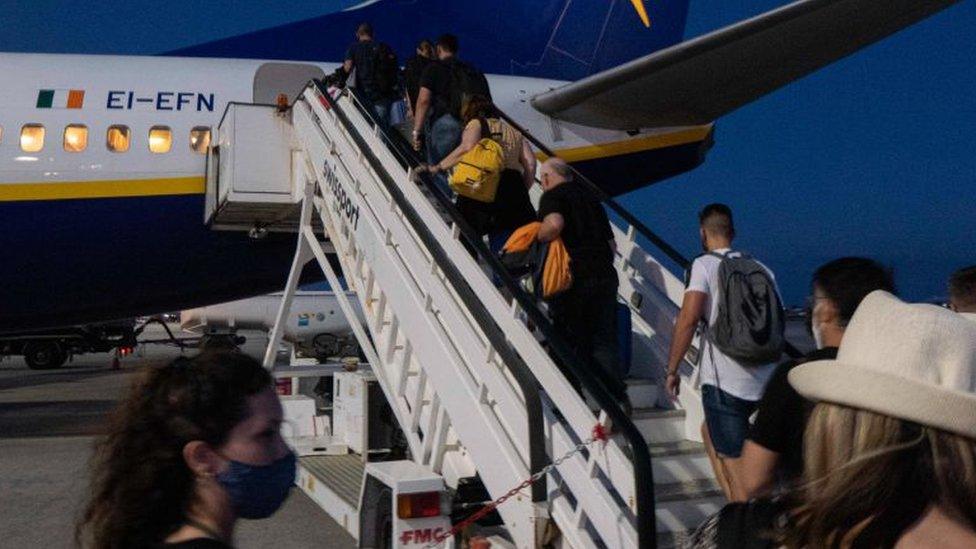 Passengers boarding plane