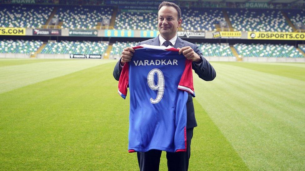 Leo Varadkar holds a Linfield FC shirt with his name on it