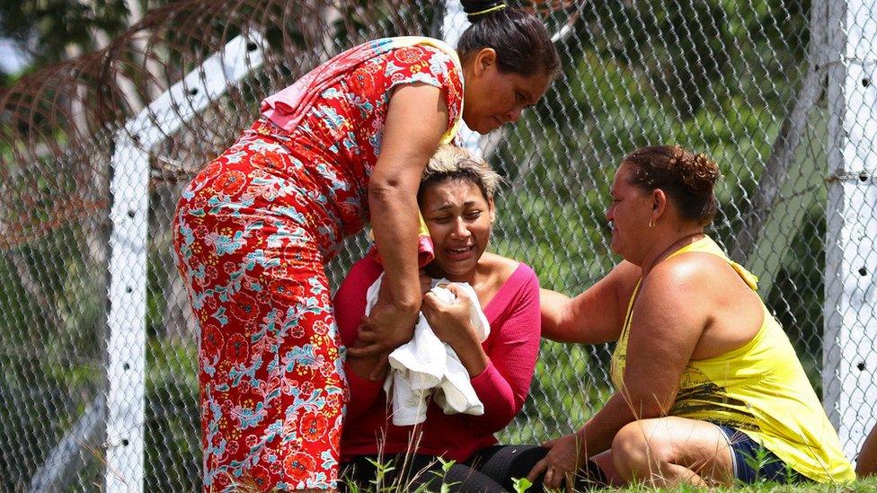 The wife of a prisoner who was killed in a riot cries outside Anisio Jobim Penitentiary Complex in Manaus