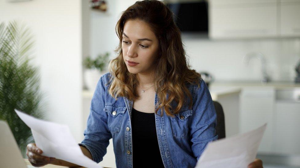 Woman looking at bills