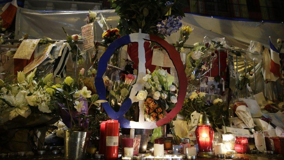 A picture taken on November 25, 2015 shows flowers and candles in front of the Bataclan theatre in memory of the victims of the November 13 attacks that left 130 dead