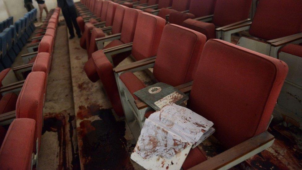 a bloodied ceremony hall at an army-run school