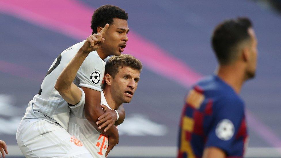 Bayern Munich's Thomas Muller celebrates scoring their first goal with Serge Gnabry