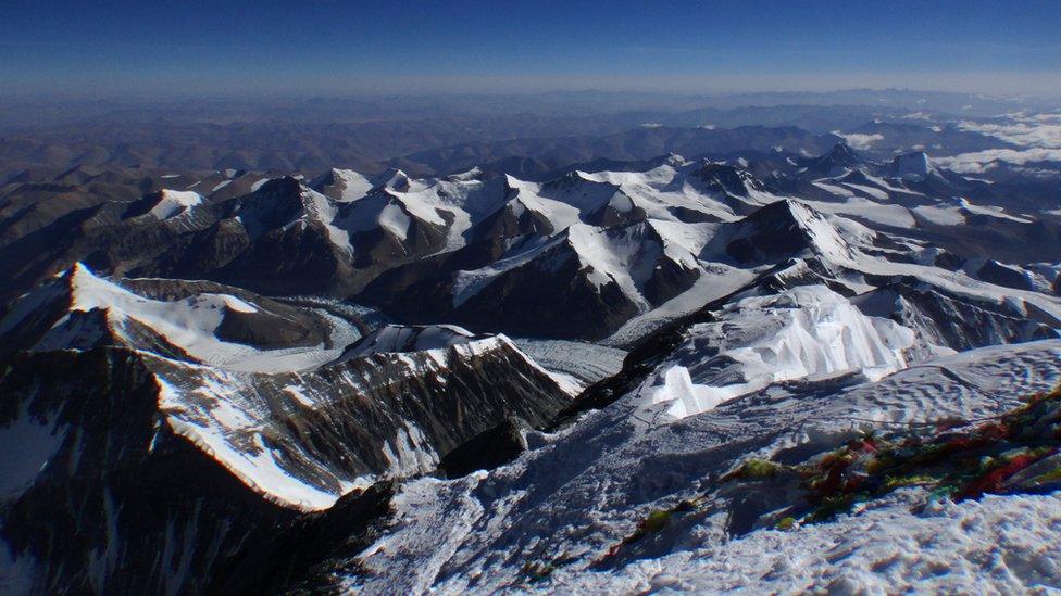 Flags lie on the summit of Mount Everest. Nepal