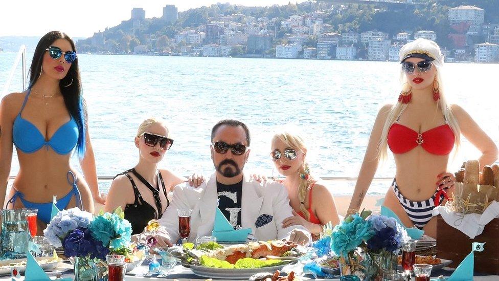 Adnan Oktar posing on a terrace by the Bosphorus in Istanbul