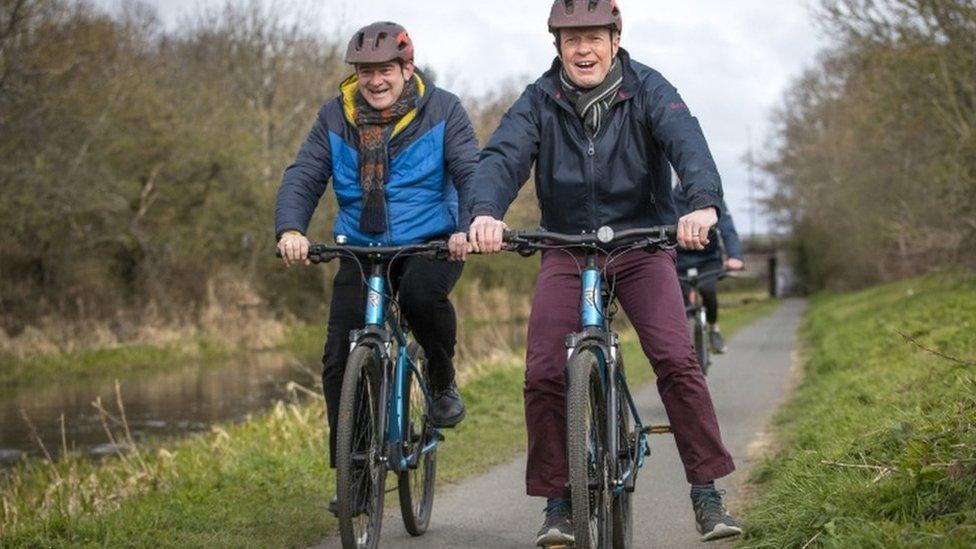 Ed Davey and Willie Rennie on bikes alongside the Union Canal in Edinburgh