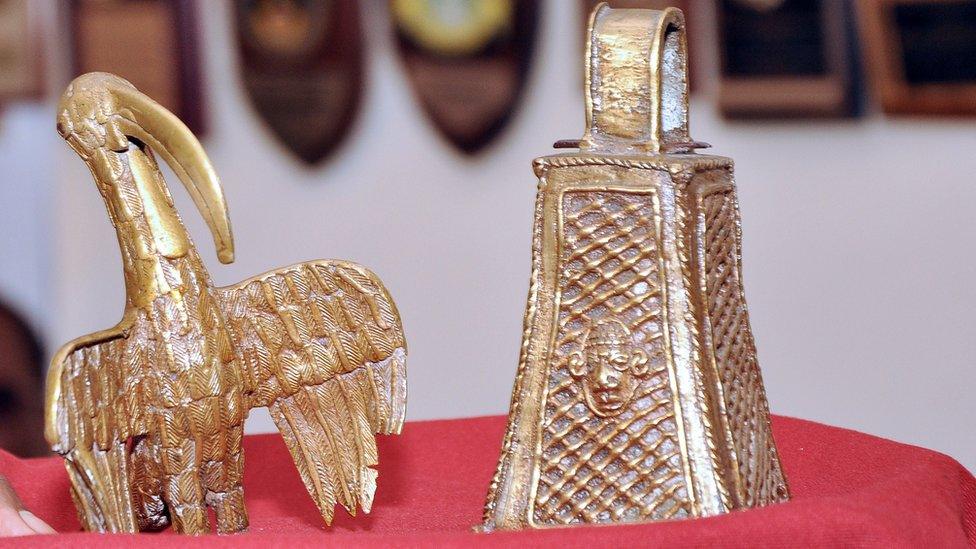 A picture shows two artefacts from the Benin Bronzes collection, a long-beaked bird and the monarch's bell, returned to the Benin kingdom by a British pensioner during a ceremony in Benin City, Nigeria, on June 20, 2014.