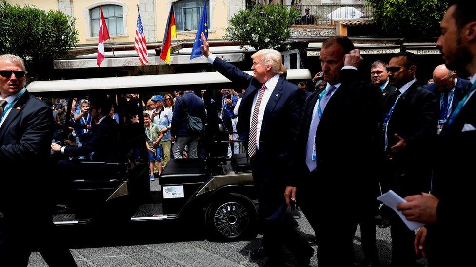 U.S. President Donald Trump waves to onlookers following a family photo at the G7 summit in Taormina, Italy May 26, 2017