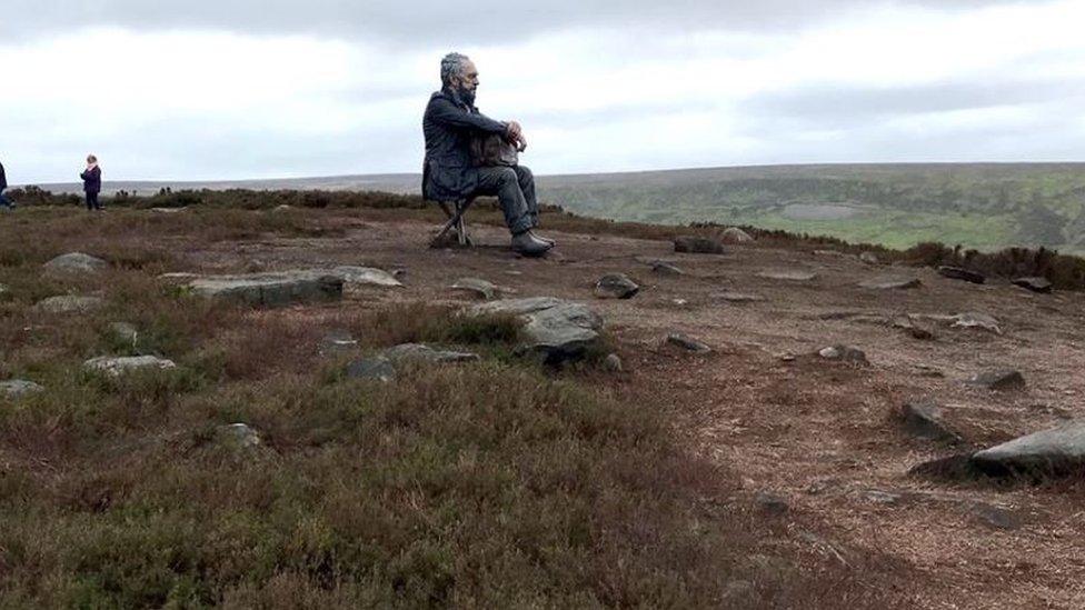 Moorland erosion around bronze figure