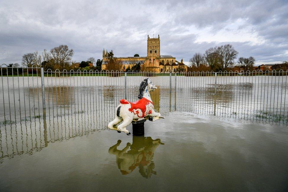 A rocking horse in a park is partially submerged in flood water around Tewkesbury Abbey, Gloucestershire, after storms and heavy rain across the UK. 16 January 2020