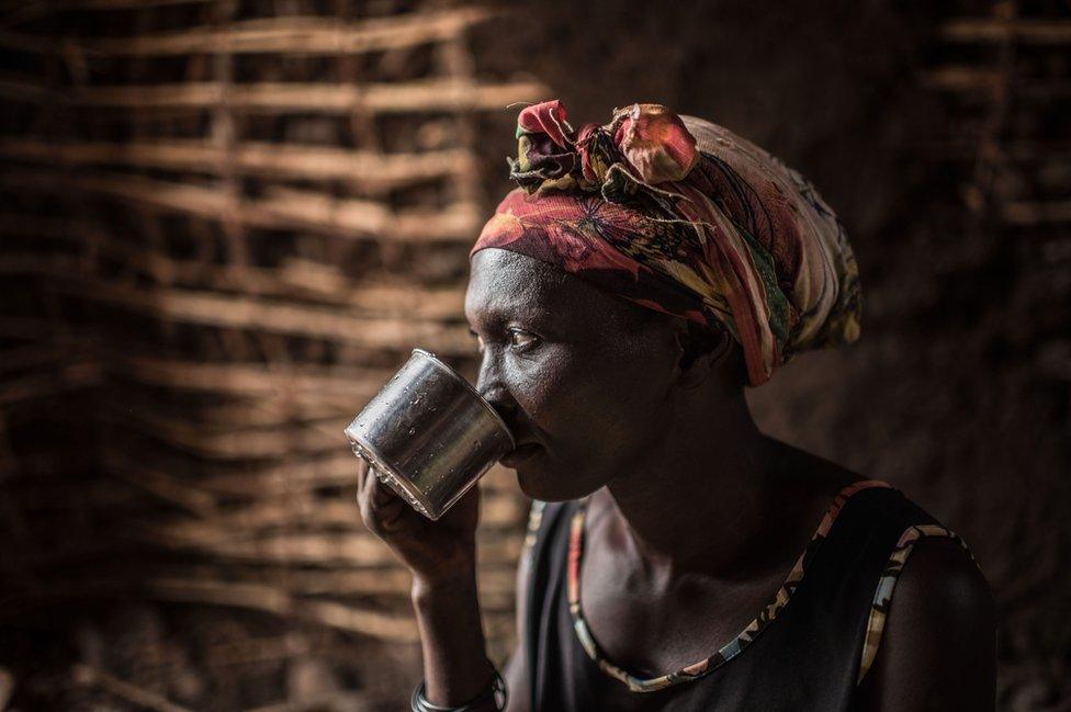 Monica Achan takes a sip of Nile water