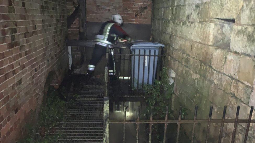 Firefighter opening sluice gate