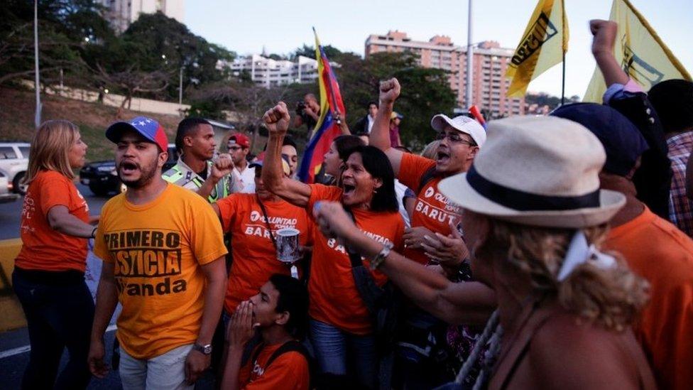 Opposition supporters block a highway during a protest against President Nicolas Maduro in Caracas, 21 March