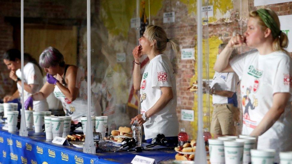 Miki Sudo (2nd R) competes in a socially-distanced women's leg of the hot dog eating competition in Brooklyn, New York