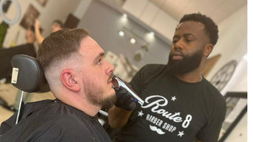 Sylvester Okoli cutting hair