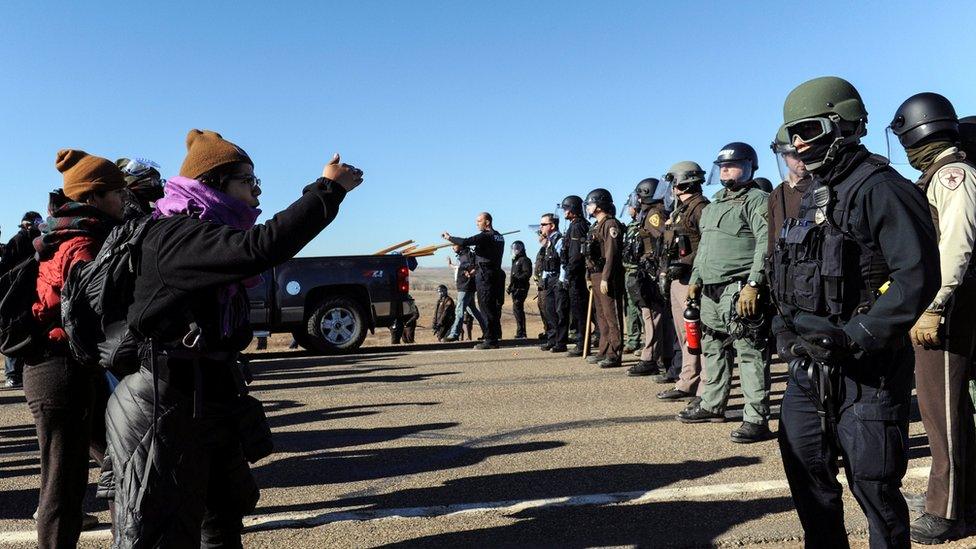 Police face people protesting against the Dakota Access pipeline