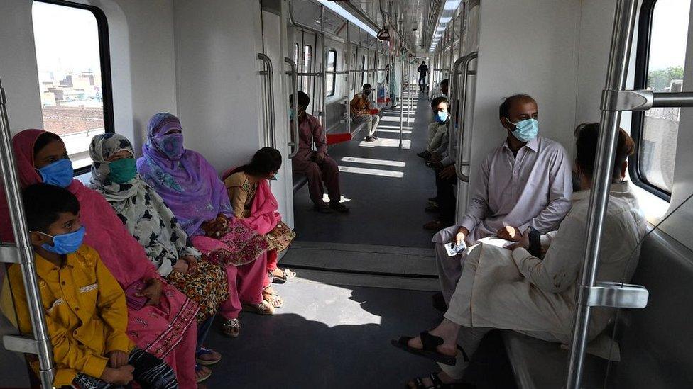 Passengers ride a train on the newly built Orange Line Metro in Lahore