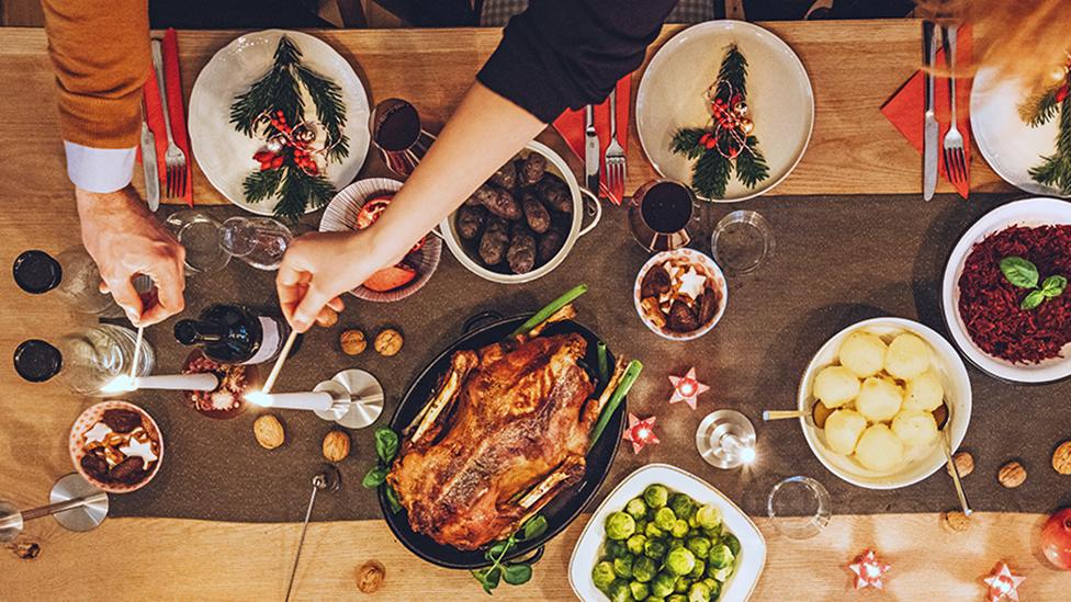 A Christmas dinner with turkey and vegetables on a table.