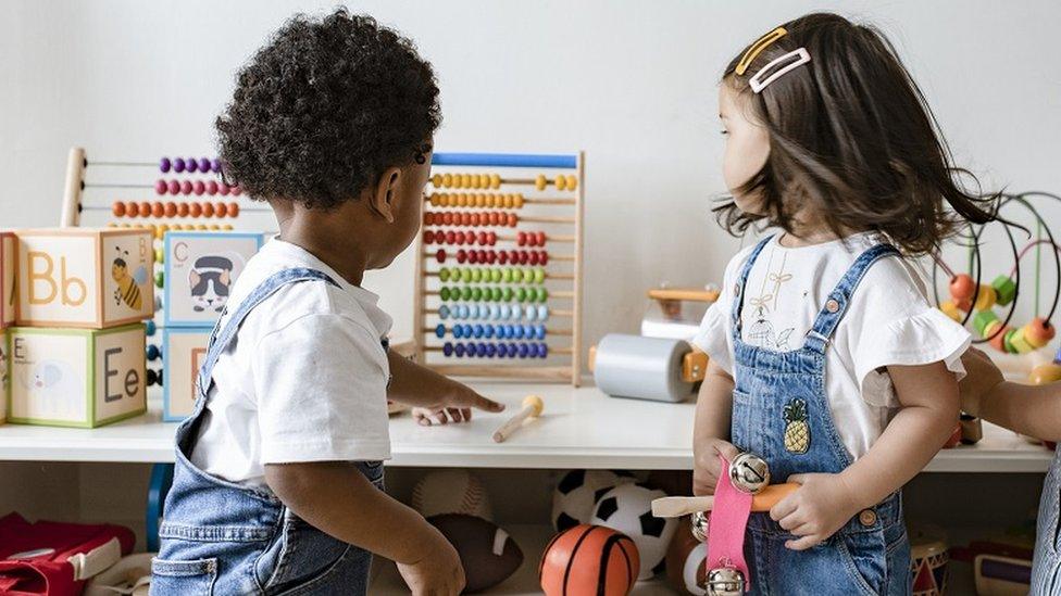 Children in nursery looking at toys