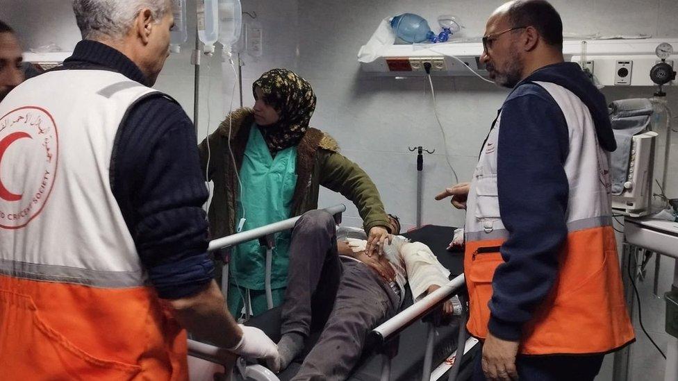 An injured Palestinian man is treated at al-Amal Hospital in Khan Younis, in the southern Gaza Strip (23 January 2024)