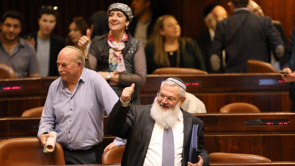 Deputy Minister Eli Ben-Dahan (front) and other Israeli lawmakers gesture as they attend a vote on the Regularisation Bill at the Knesset on 6 February 2017