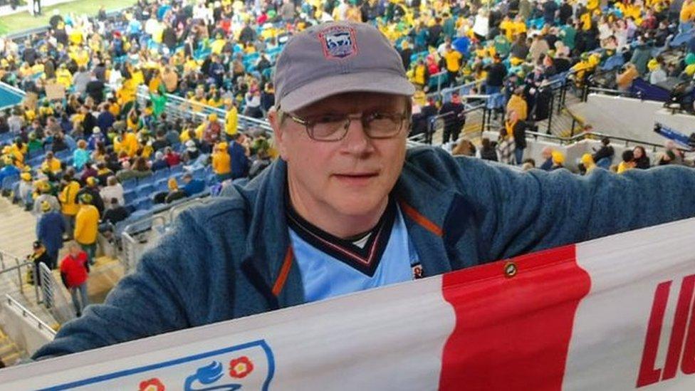 Ian Wallis holding an England flag