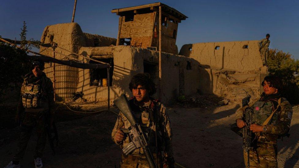 Hazrat Bilal, 24, center, and other Afghan National Police officers patrol areas of the road heading towards the Panjwai district outside of Kandahar, Afghanistan, on Sunday Oct. 25, 2020