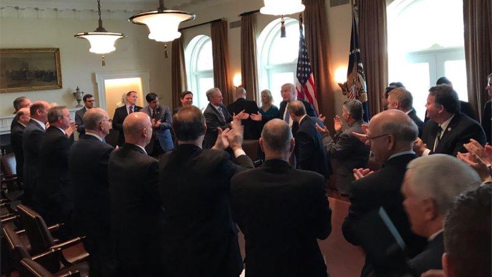 Another photograph of the meeting shows one woman, Kellyanne Conway, present