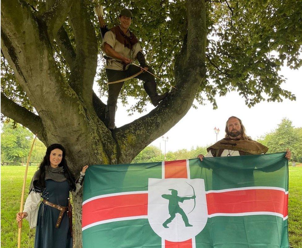 Robin Hood, Lady Marian and Little John attending the flag raising event