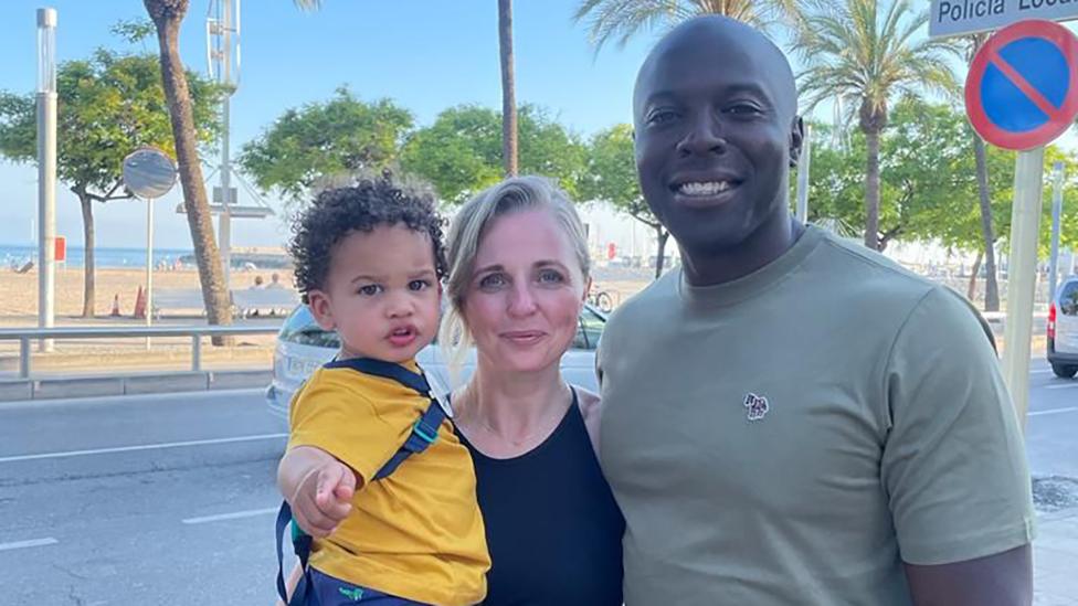 Group picture of Addy, Jodie and Gavin on a street with trees and blue sky in the background