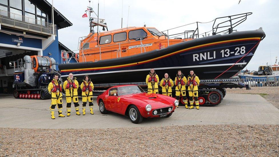 The new lifeboat, called the Richard and Caroline Colton, and the lifeboats crew, with a 1960 red Ferrari 250 GT SWB which sold for £6.6m