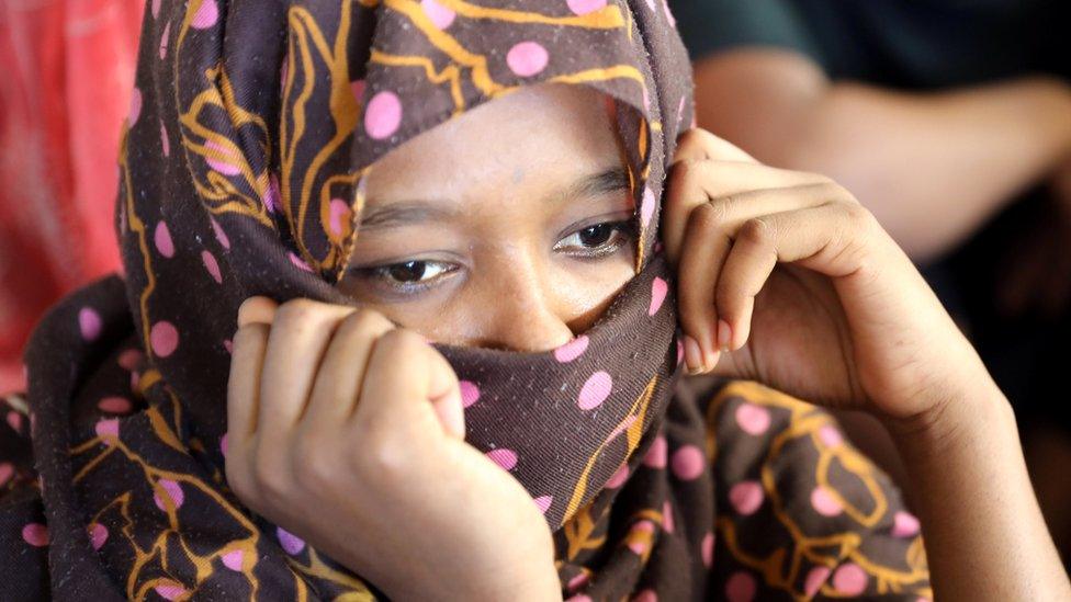 A migrant is seen in a shelter after being relocated from a government-run detention centre following violence in Libya's Tripoli