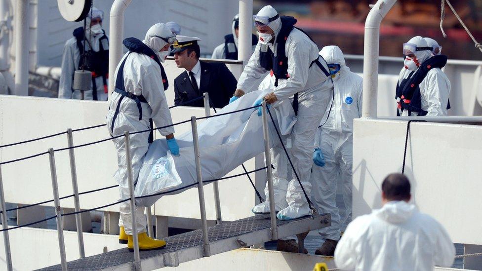 The body of person who died after fishing boat carrying migrants capsized off the Libyan coast, is brought ashore along with 23 others retrieved by the Italian Coast Guard vessel Bruno Gregoretti at Boiler Wharf, Senglea in Malta on April 20, 2015