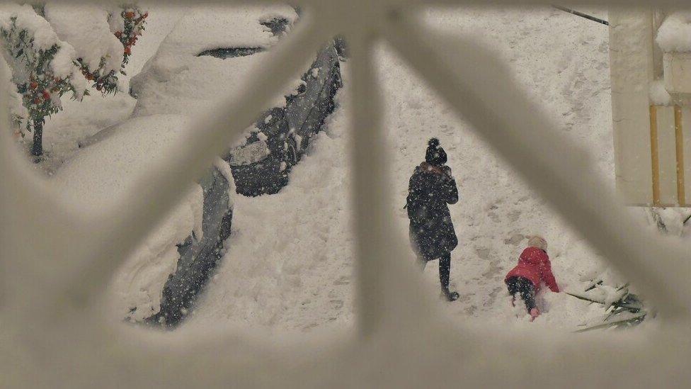 Mother and child on a snowy street