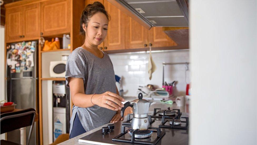 Woman making an espresso on a gas hob