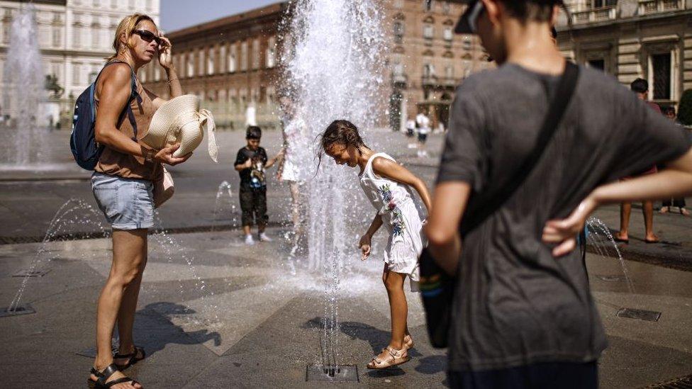 Children play in a fountain