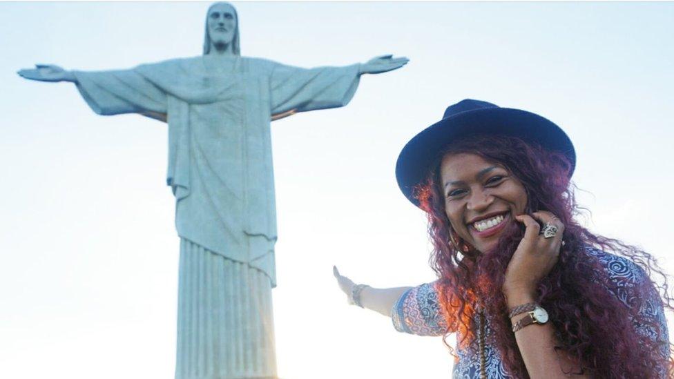 Gloria points to the Jesus statue in Rio de Janiero