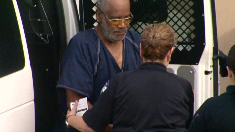 Truck driver James Mathew Bradley getting out of the police van, handcuffed