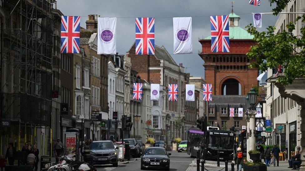 Union and Platinum Jubilee flags are pictured in Colchester, eastern England on May 31, 2022, as preparations got underway ahead of the Queen's Platinum Jubilee