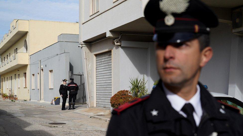 Carabinieri standing guard outside Messina Denaro's hideout in Campobello di Mazara