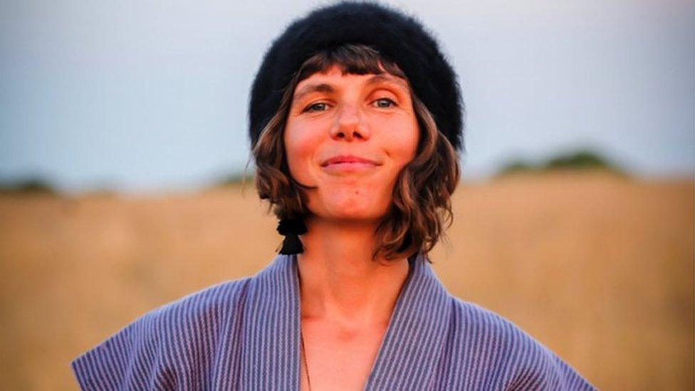 Image of Rachael Dadd. She is pictured outside with a field behind her. She is looking directly at the camera and smiling.