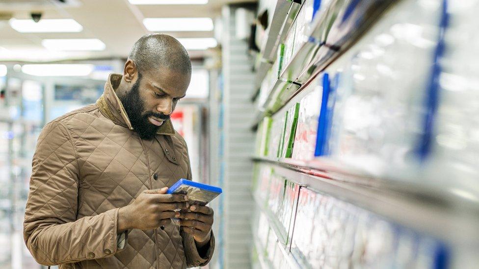 A stock image of a man buying computer games